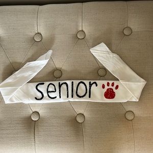 White bandana with Senior written on it